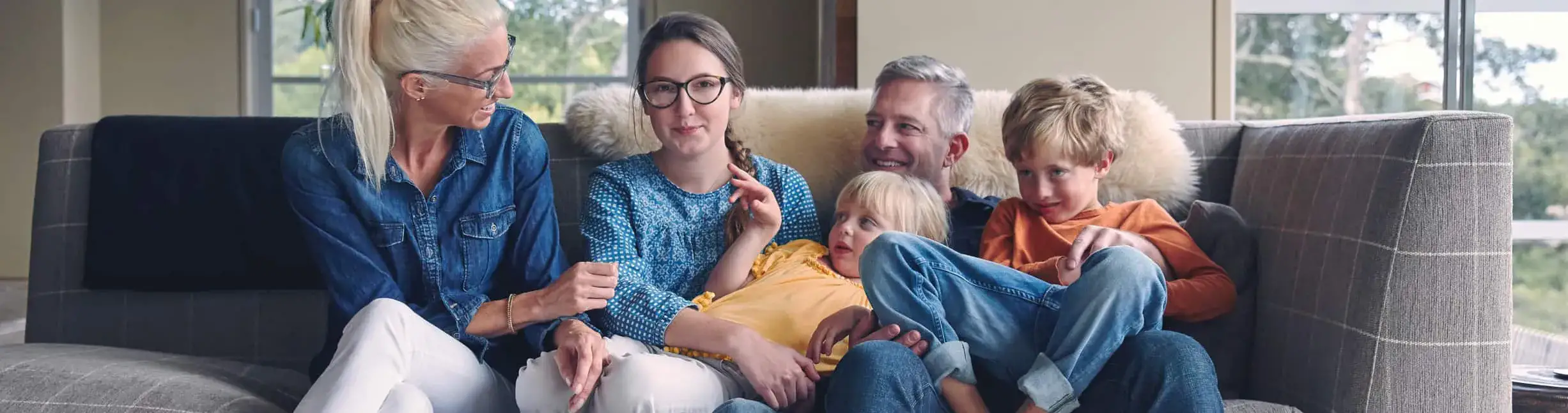 A group of people sitting on top of a couch.