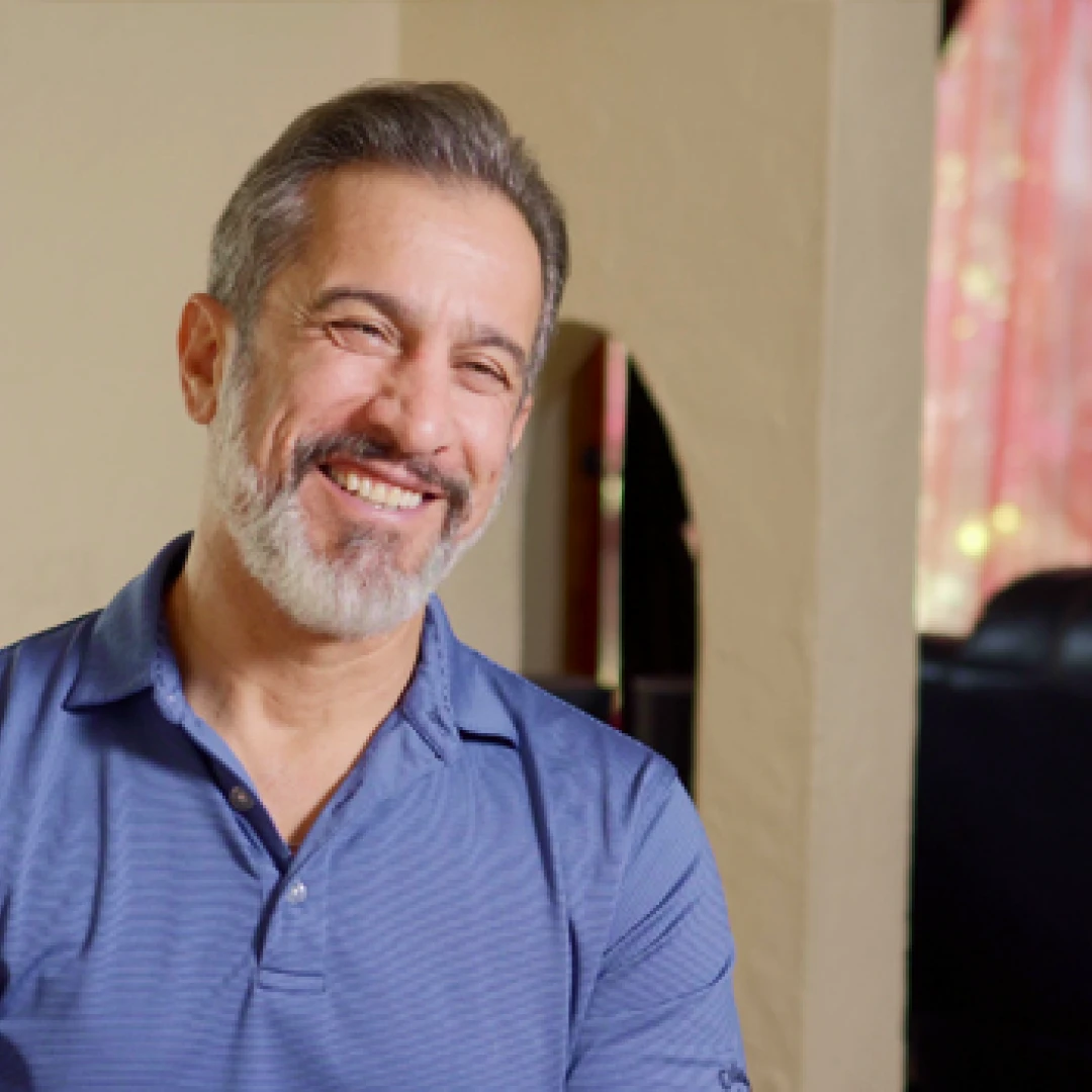 A man with a beard and a blue shirt.