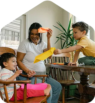 A woman and two children sitting at a table.