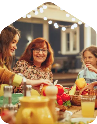 A group of people sitting around a table with food.
