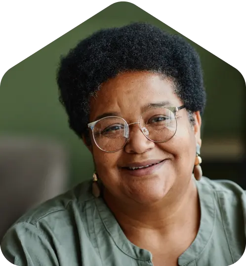 A woman wearing glasses and a green shirt.